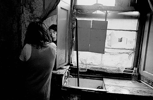 Applying eye makeup in a Gorbals tenement flat, Glasgow  (1970)