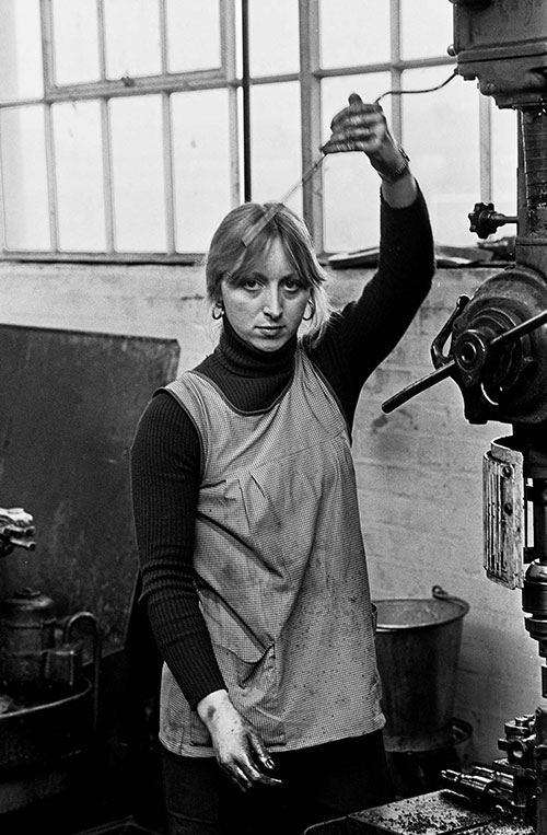 Girl at drilling machine with oil lubricant, Lee Howl pump factory Tipton  (1978)