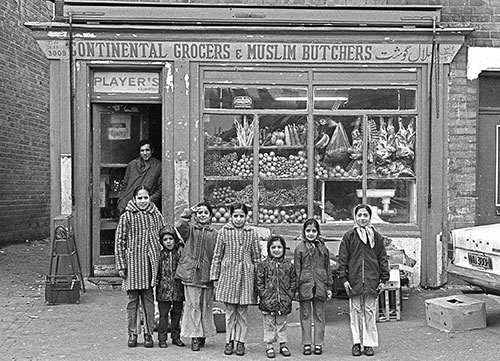 children posing  outside their uncle's shop, Saltley, Birmingham  (1976)