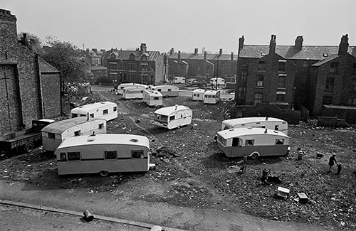 Travellers' vans occupy a slum cleared site, Manchester  (1969)