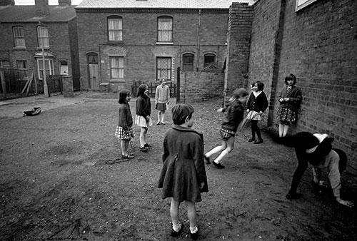 children playing in the backyard of their terraced homes, Birmingham
