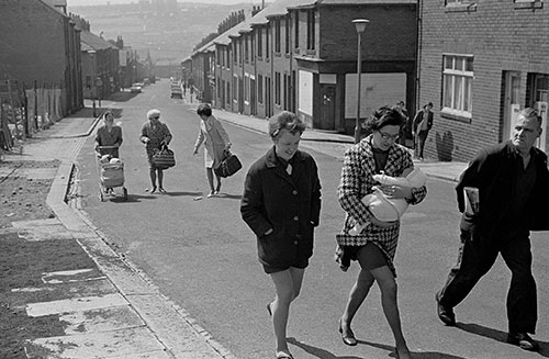 Family groups walk up a Byker street, Tyneside  (1970)