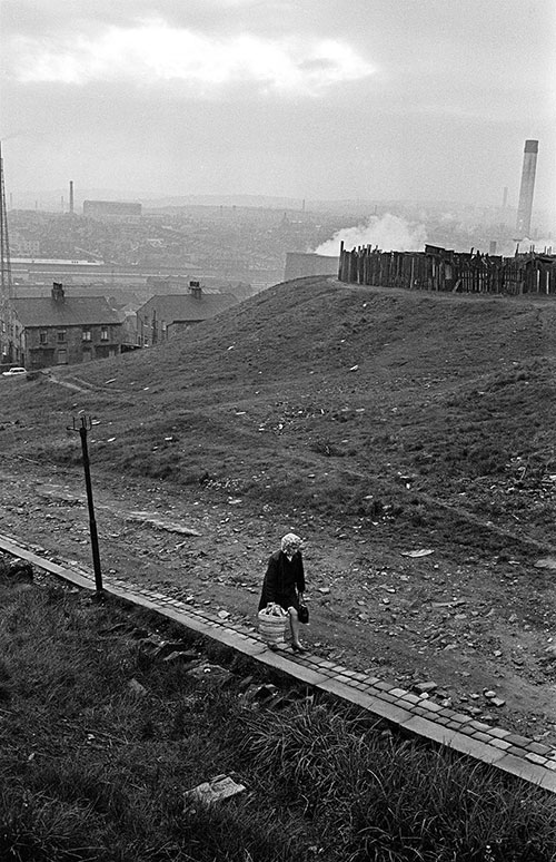 Woman climbing the hill towards home, Bradford  (1969)