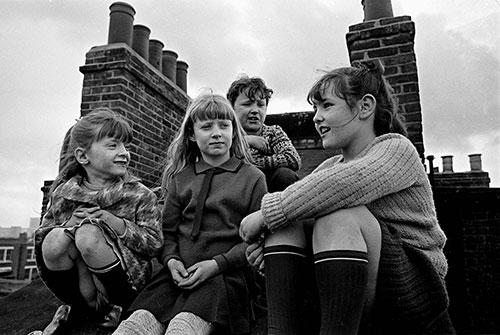 Gang of friends chatting on the roof of their Lambeth tenement  (1969)