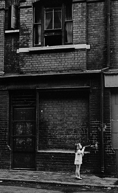 Child blowing bubbles, Whitechapel, London  (1969)