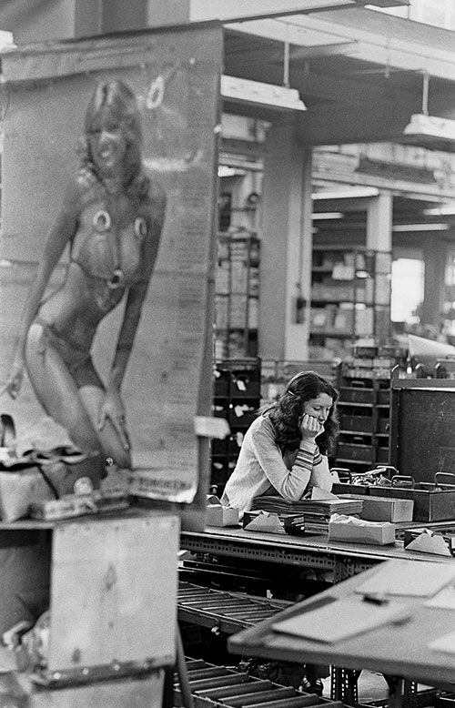 Travel poster and girl in packing department, Josiah Parkes lock factory Willenhall  (1976)