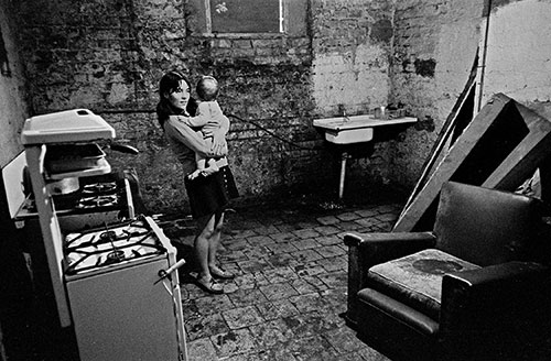 Mother and baby in the cellar kitchen of their Liverpool home,  (1971)