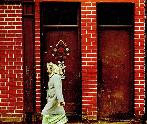 Woman passing by a brightly painted house Saltley Birmingham  (1966)