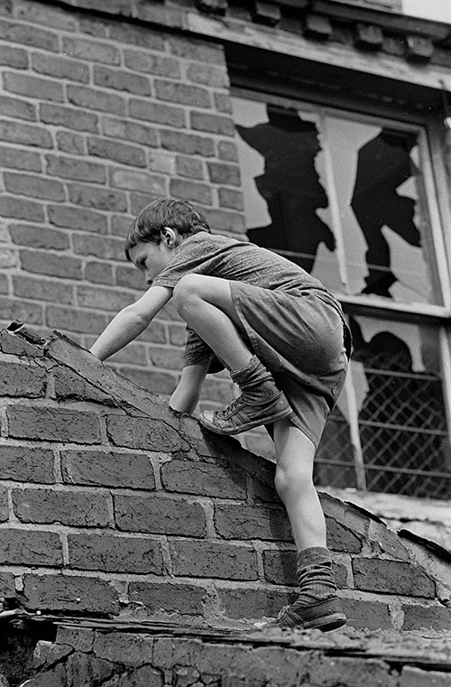 Boy playing on derelict property Birmingham  (1971)