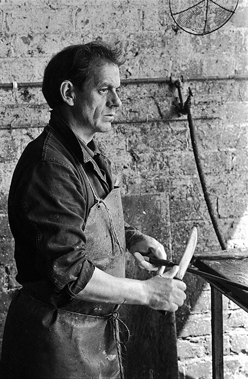 A gutter sharpening his knife, North Shields  (1979)