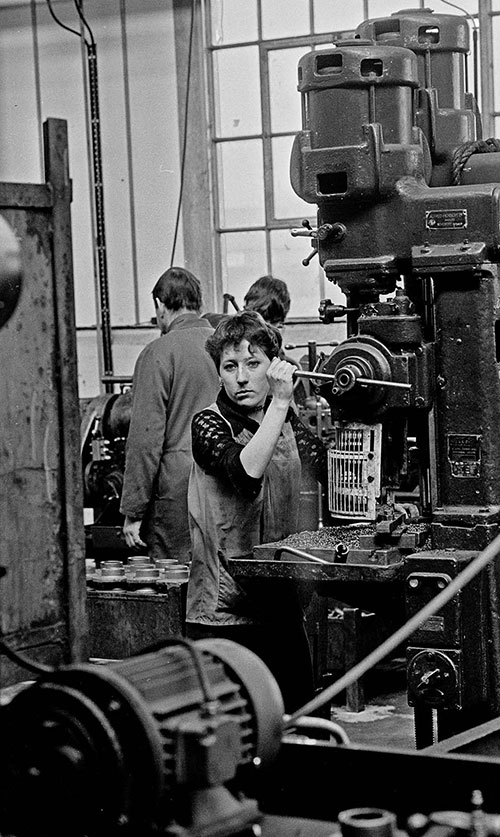 Girl pulling lever on a drilling machine, Lee Howl pump factory Tipton  (1978)