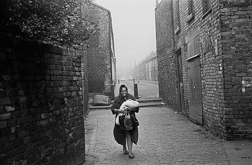 Mother and baby walking through a Liverpool alleyway,  (1969)