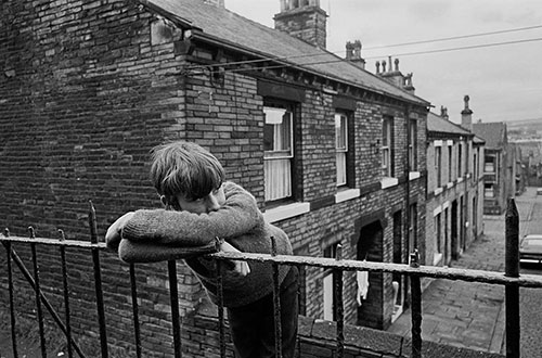 Teenage boy leaning on the railings in a Bradford street  (1972)