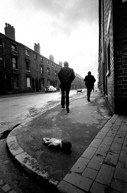 Children race up a Ladywood clearance zone street, Birmingham  (1968)