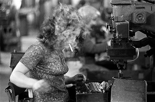 Lock assembler wreathed in smoke, Josiah Parkes lock factory Willenhall  (1976)