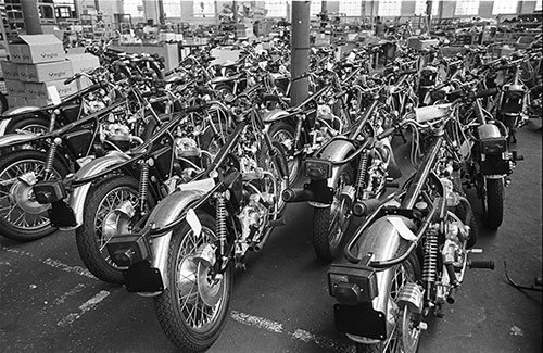 a phalanx of unfinished Norton motorcycles, Wolverhampton  (1976)