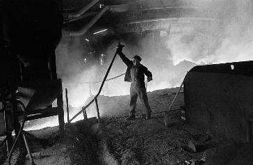 photograph of man working in foundry